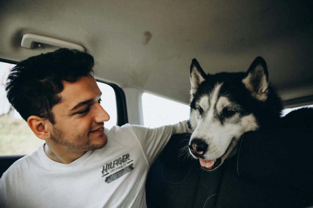 Smiling Man with Dog in Car